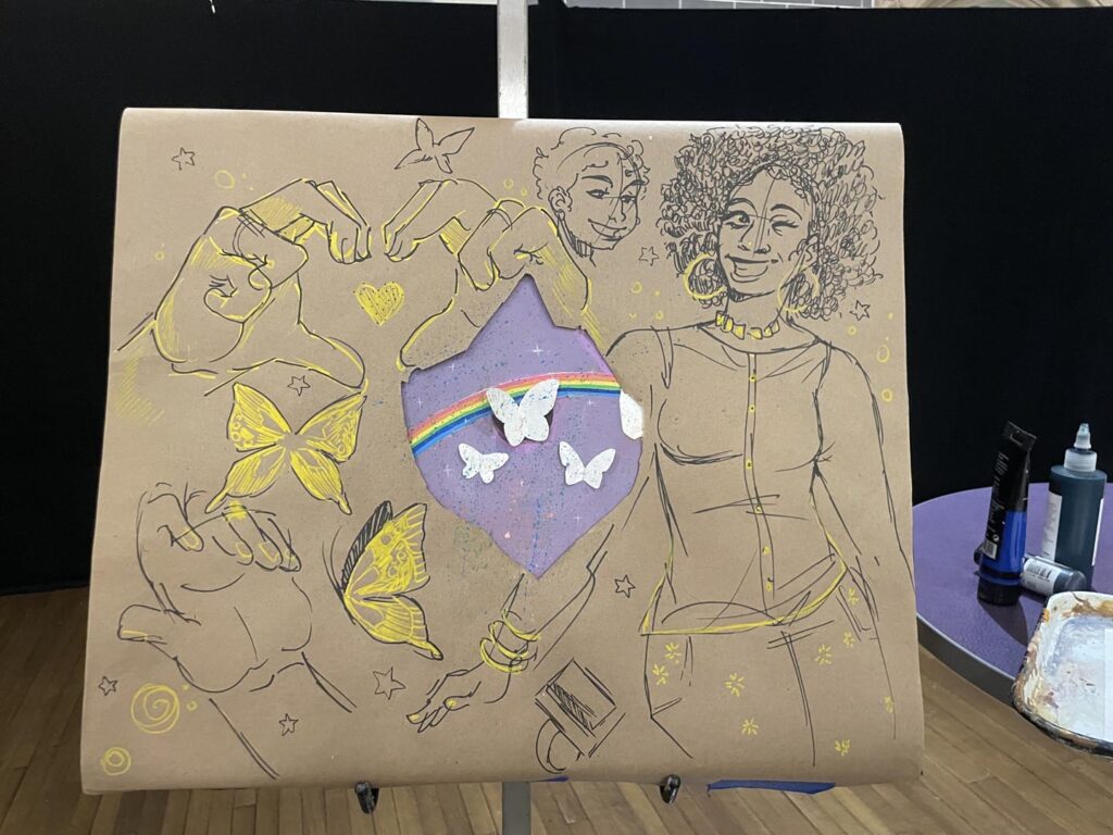 The work Ileana Kuran did before revealing her final Black Excellence Piece. Mostly Hands, butterflies, and two black women.